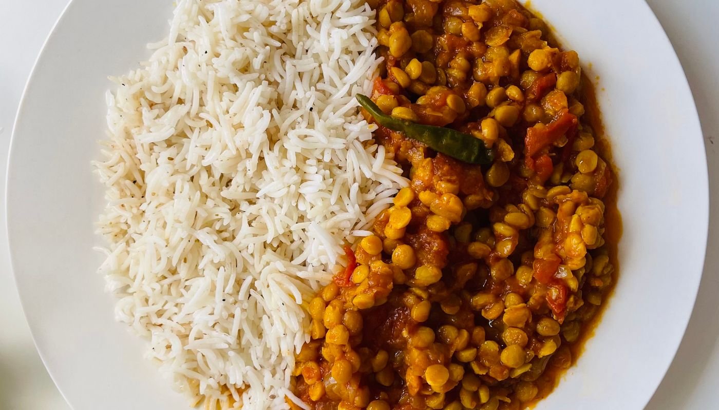 A plate of rice, lentils and vegetables